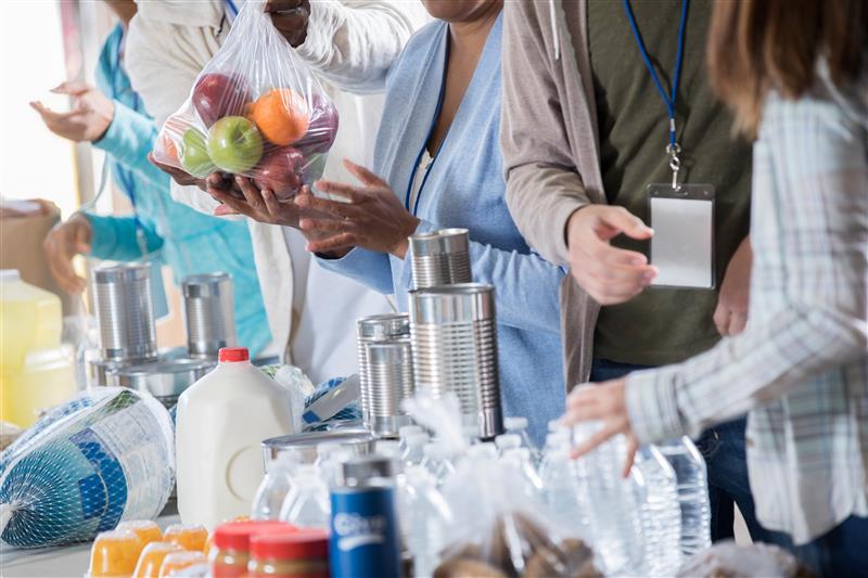 People packing groceries at a food drive